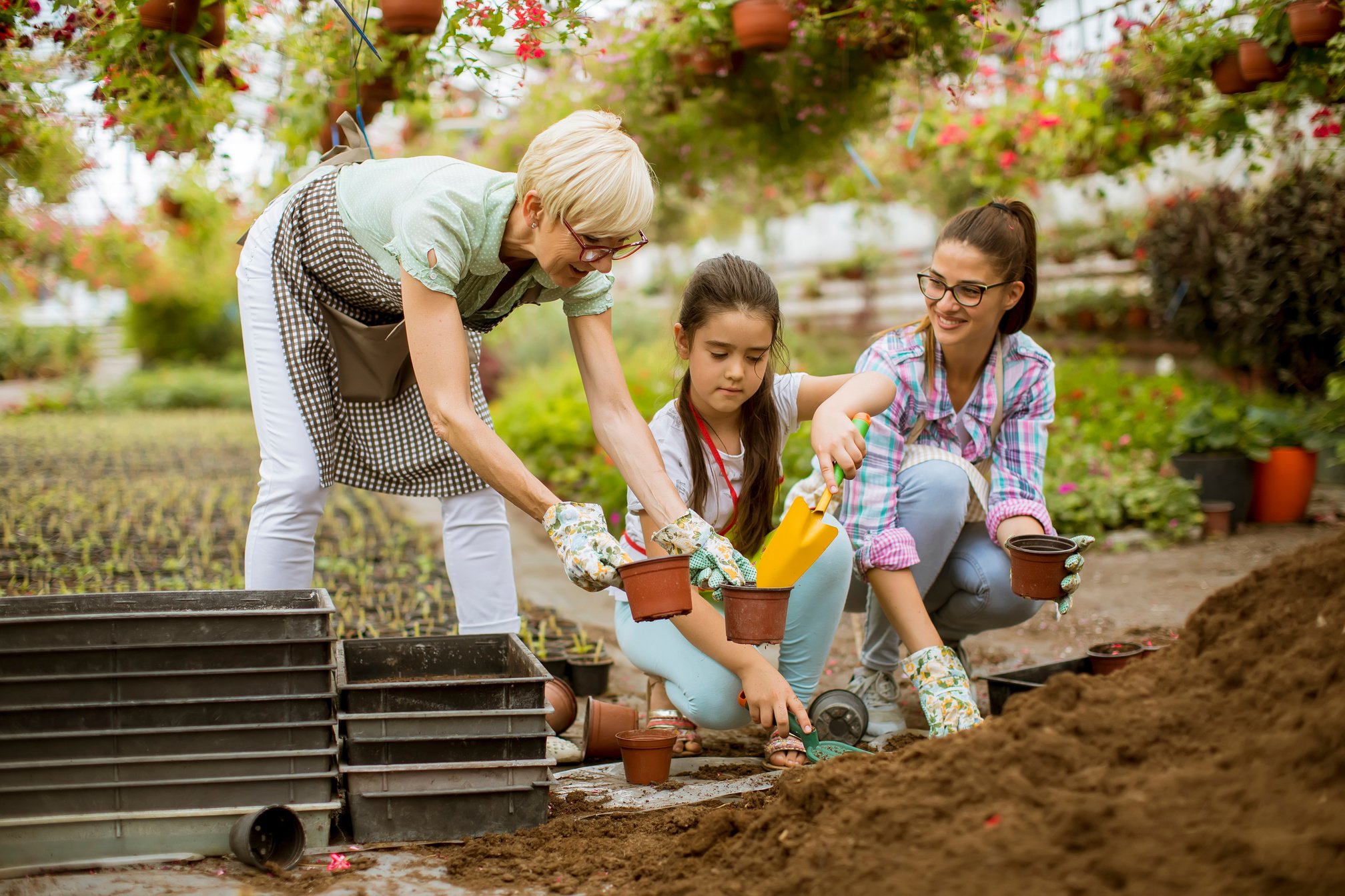 People Planting Flowers with Pots